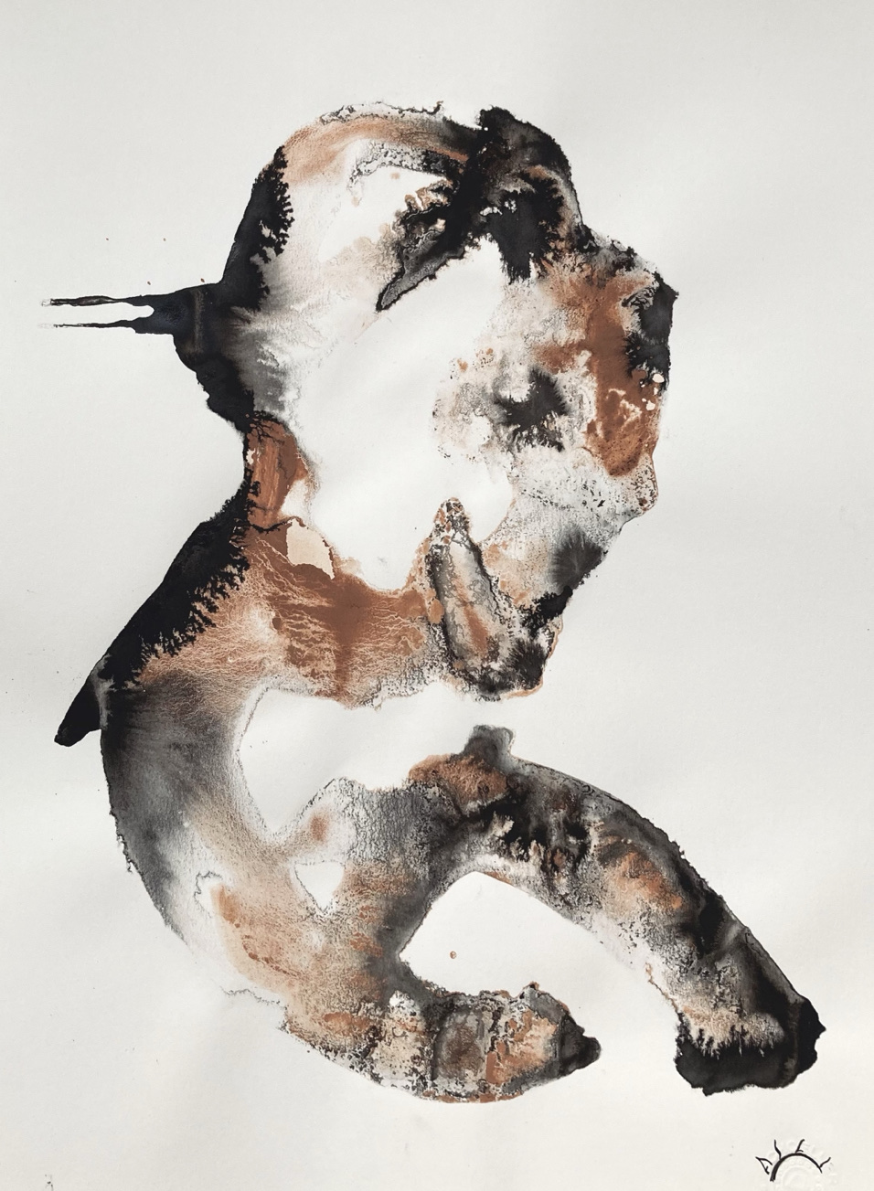 Brown and black profile-like figure on white paper.